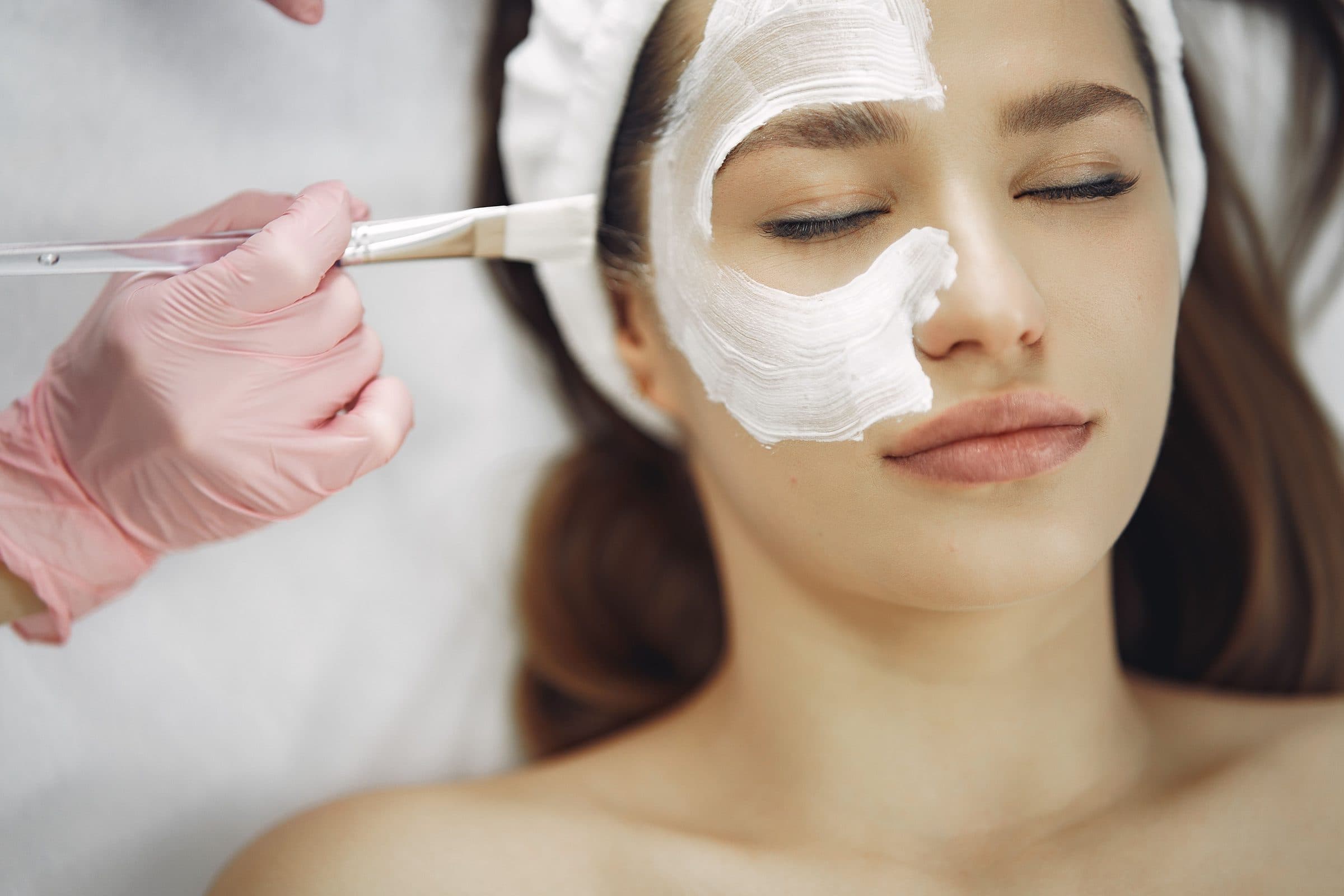 Treatment being applied to the face with a soft brush